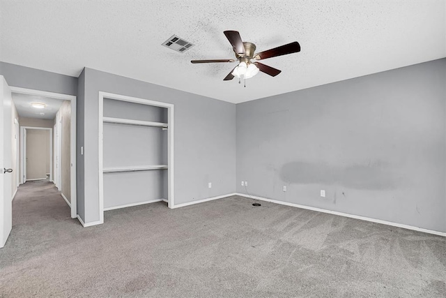 unfurnished bedroom with visible vents, carpet floors, a closet, baseboards, and a textured ceiling