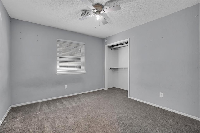 unfurnished bedroom with carpet, a closet, and a textured ceiling