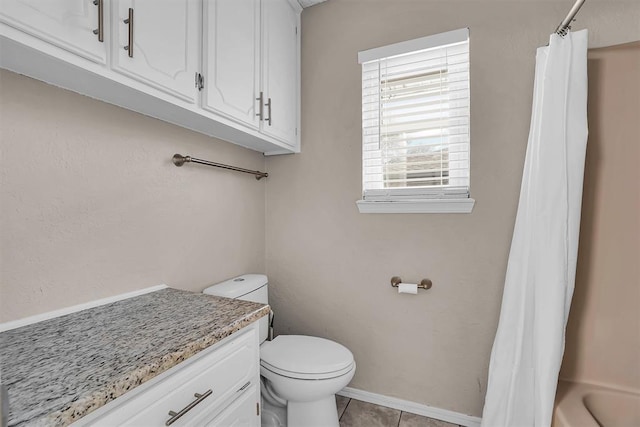 bathroom with toilet, tile patterned floors, baseboards, and vanity