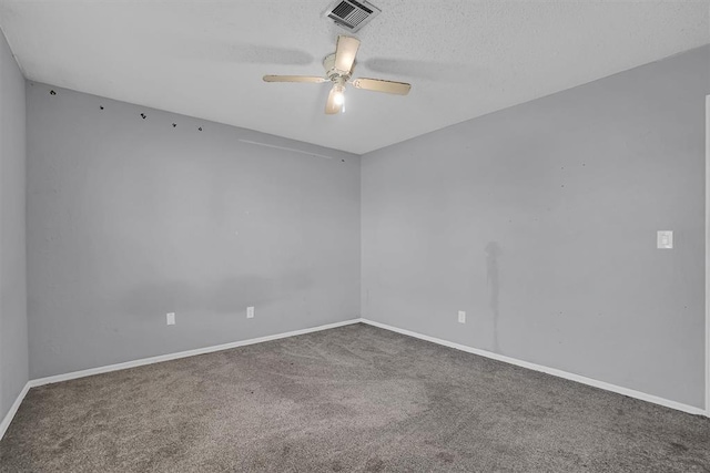 carpeted empty room with visible vents, a ceiling fan, and baseboards