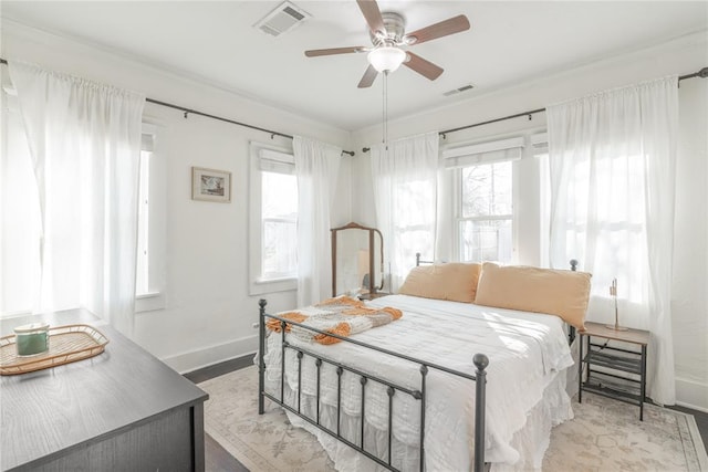 bedroom with baseboards, multiple windows, and visible vents