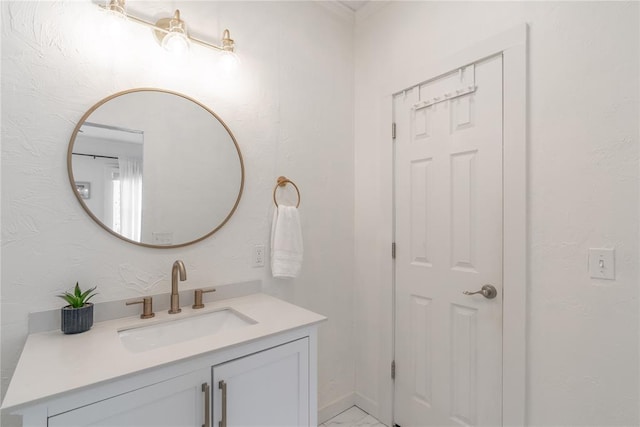 bathroom featuring marble finish floor and vanity