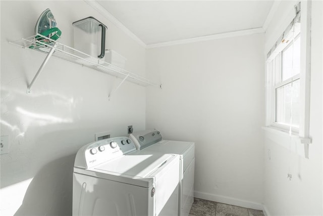laundry room featuring laundry area, ornamental molding, baseboards, and washer and clothes dryer