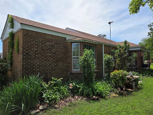 view of side of property featuring brick siding