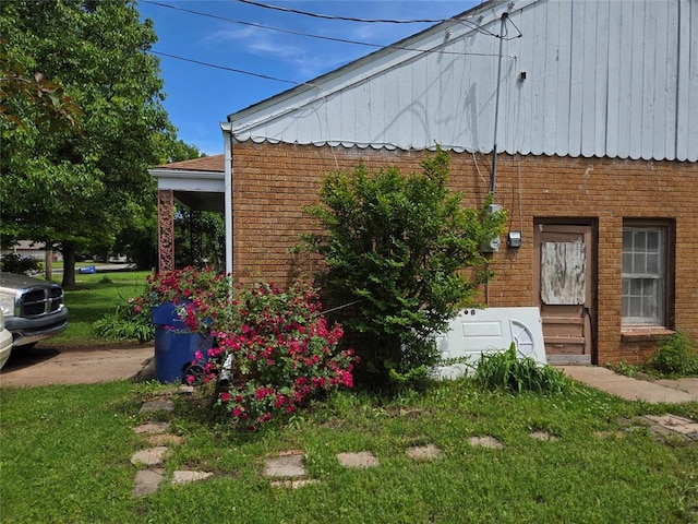 view of home's exterior with brick siding and entry steps