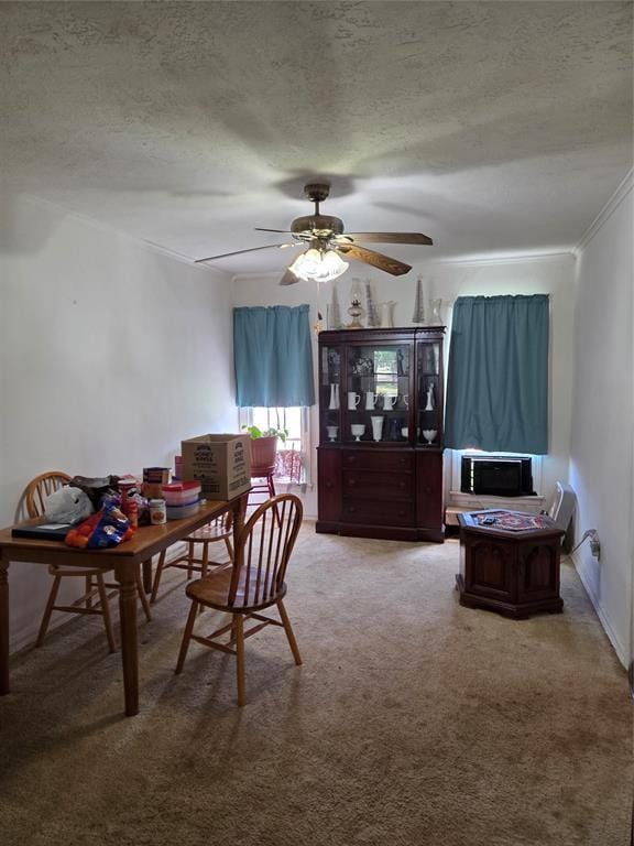 carpeted dining room featuring a ceiling fan and a textured ceiling
