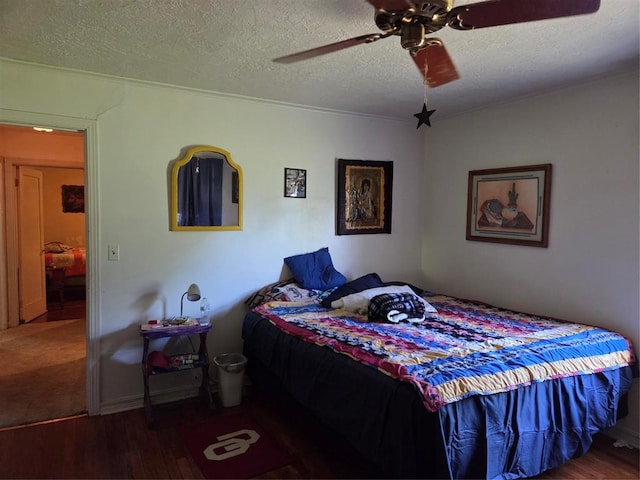 bedroom featuring a ceiling fan, a textured ceiling, and wood finished floors