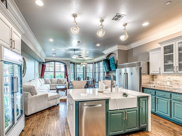 319 NE 1st St, Oklahoma City, OK 73104 - kitchen featuring appliances with stainless steel finishes, a sink, white cabinetry, open floor plan, and visible vents