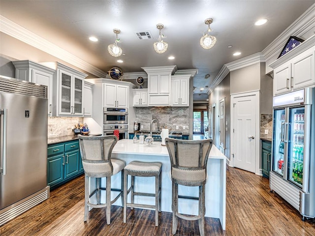 319 NE 1st St, Oklahoma City, OK 73104 - kitchen with visible vents, ornamental molding, dark wood-type flooring, and stainless steel appliances