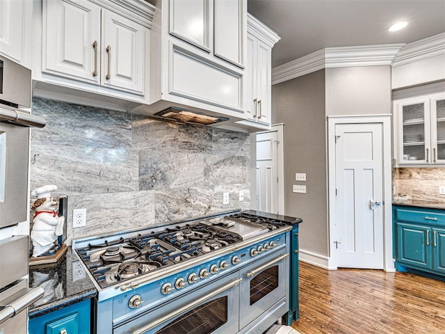 319 NE 1st St, Oklahoma City, OK 73104 - kitchen with range with two ovens, tasteful backsplash, white cabinets, glass insert cabinets, and ornamental molding