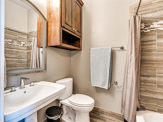 319 NE 1st St, Oklahoma City, OK 73104 - bathroom with a sink, baseboards, toilet, and wood finished floors