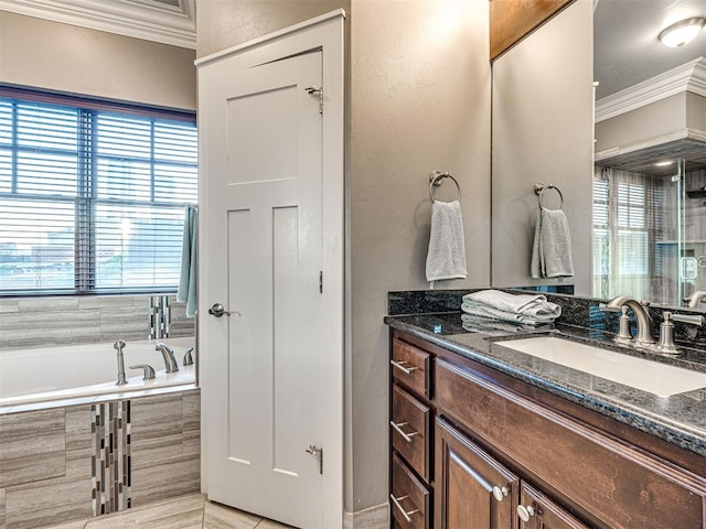 319 NE 1st St, Oklahoma City, OK 73104 - bathroom featuring vanity, ornamental molding, a textured wall, and a bath
