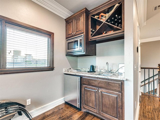 319 NE 1st St, Oklahoma City, OK 73104 - bar with crown molding, a sink, dark wood finished floors, and appliances with stainless steel finishes