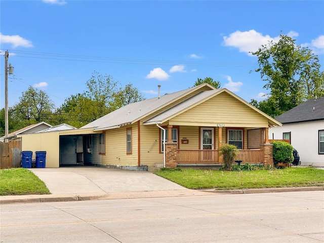 903 Sunset Dr, El Reno, OK 73036 - ranch-style home with driveway, a front yard, and covered porch