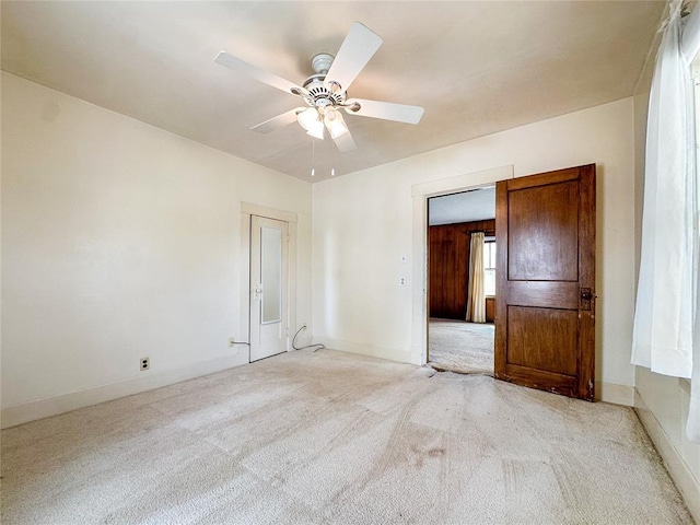 903 Sunset Dr, El Reno, OK 73036 - unfurnished bedroom with light colored carpet, baseboards, and ceiling fan