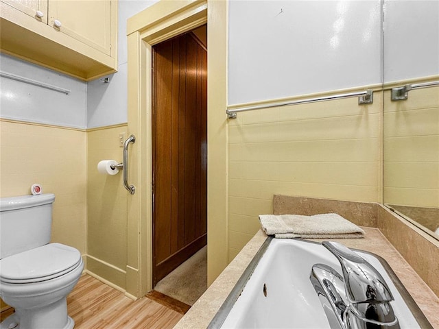 903 Sunset Dr, El Reno, OK 73036 - bathroom with toilet, a sink, and wood finished floors