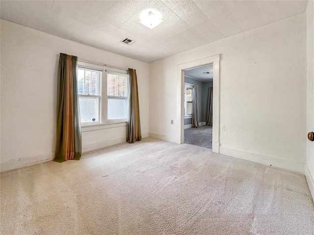 903 Sunset Dr, El Reno, OK 73036 - carpeted spare room with baseboards and visible vents