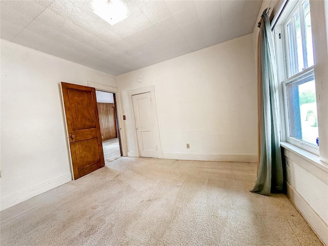 903 Sunset Dr, El Reno, OK 73036 - unfurnished room with plenty of natural light and carpet