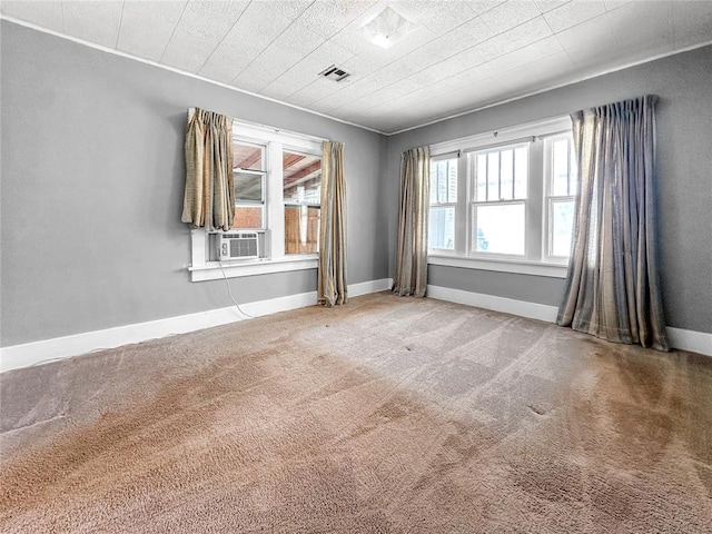 903 Sunset Dr, El Reno, OK 73036 - carpeted empty room with baseboards, cooling unit, and visible vents