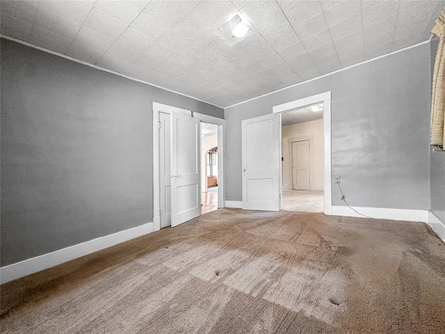 903 Sunset Dr, El Reno, OK 73036 - spare room featuring carpet flooring and baseboards