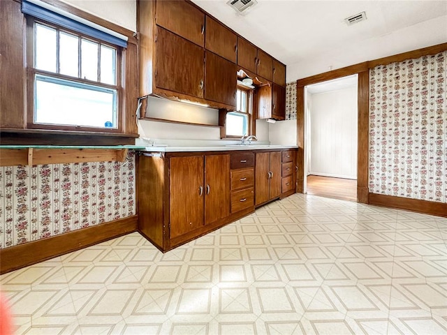 903 Sunset Dr, El Reno, OK 73036 - kitchen featuring light countertops, light floors, baseboards, and visible vents