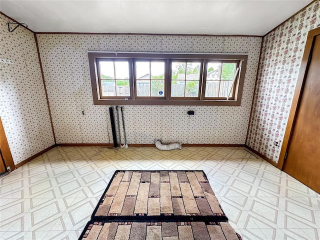 903 Sunset Dr, El Reno, OK 73036 - spare room with tile patterned floors, plenty of natural light, baseboards, and wallpapered walls