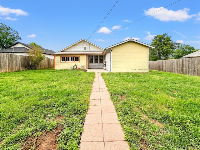 903 Sunset Dr, El Reno, OK 73036 - view of front of property featuring a fenced backyard, a front yard, and a patio area
