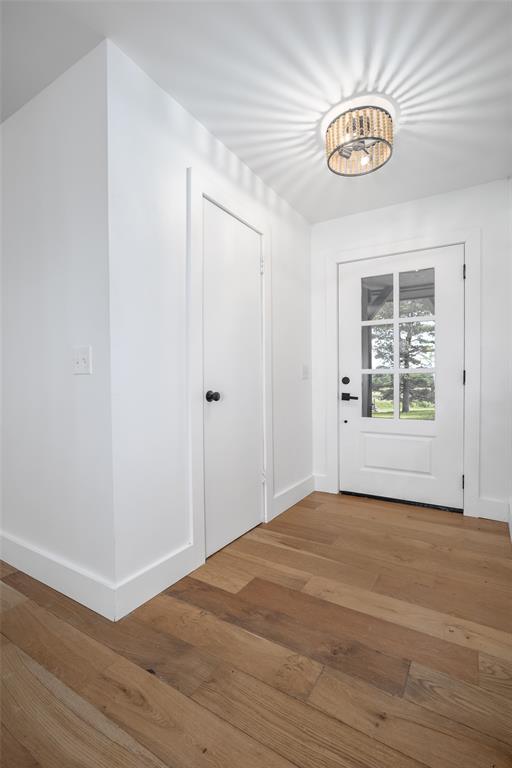 entryway with light wood-style floors and baseboards