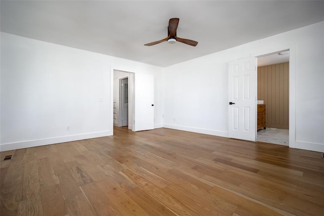 unfurnished bedroom with baseboards, ceiling fan, wood finished floors, and visible vents