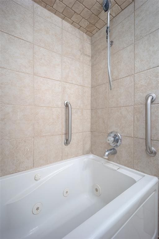 bathroom with a combined bath / shower with jetted tub