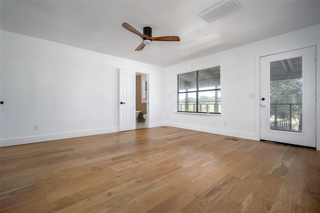empty room with visible vents, light wood finished floors, and a healthy amount of sunlight