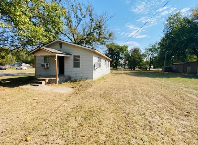 view of home's exterior featuring a lawn and cooling unit