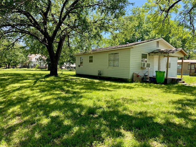 501 E Broadway, Okemah, OK 74859 - back of house featuring a lawn and cooling unit