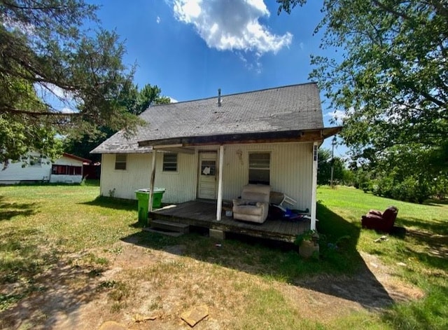back of property featuring a lawn