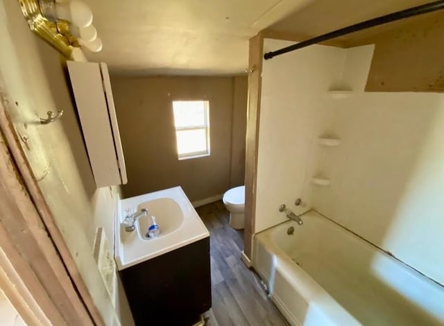 full bathroom featuring vanity, shower / bathtub combination, wood finished floors, and toilet