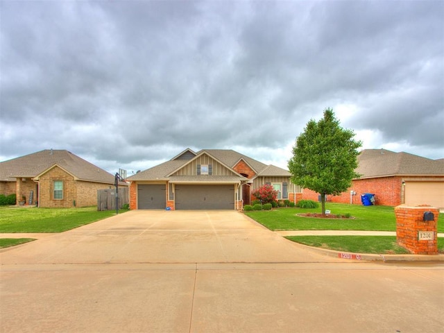 view of front facade featuring brick siding, a garage, a front lawn, and driveway