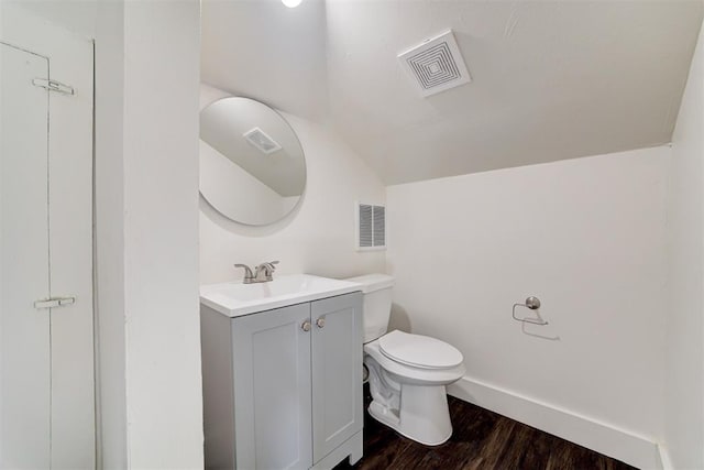 2841 NW 20th St, Oklahoma City, OK 73107 - bathroom with visible vents, lofted ceiling, toilet, and vanity