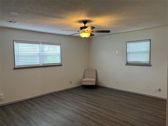 3233 SW 40th St, Oklahoma City, OK 73119 - spare room featuring visible vents, a textured ceiling, dark wood-style flooring, and ceiling fan