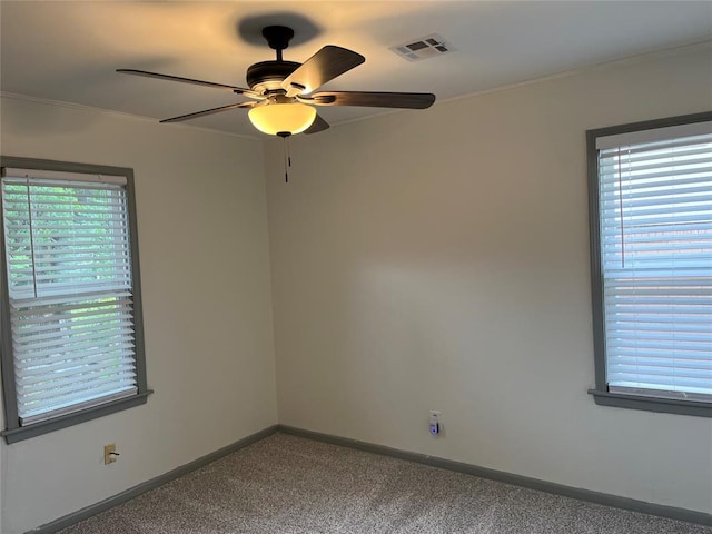 3233 SW 40th St, Oklahoma City, OK 73119 - carpeted spare room with crown molding, baseboards, ceiling fan, and visible vents