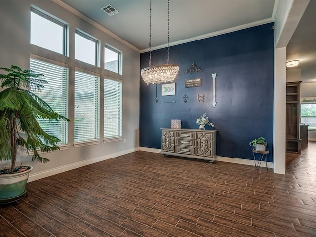 7437 SW 105th St, Oklahoma City, OK 73173 - dining room with a notable chandelier, baseboards, wood finished floors, visible vents, and ornamental molding