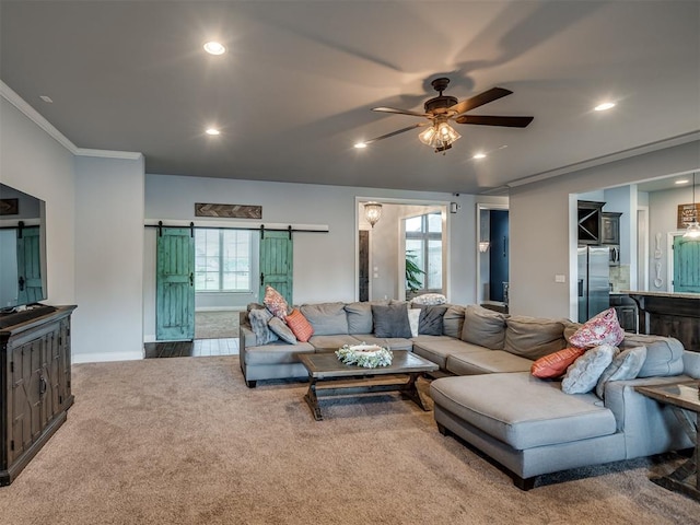 7437 SW 105th St, Oklahoma City, OK 73173 - carpeted living room with crown molding, a barn door, recessed lighting, a ceiling fan, and baseboards