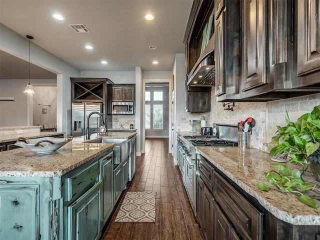 7437 SW 105th St, Oklahoma City, OK 73173 - kitchen with visible vents, decorative backsplash, dark wood-style flooring, a sink, and stainless steel appliances