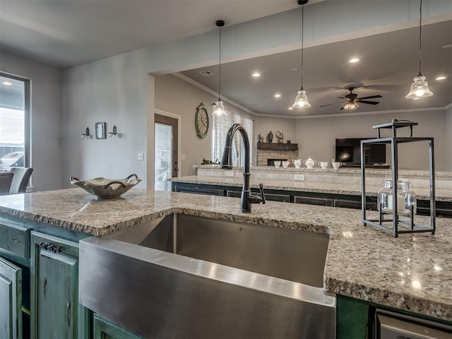 7437 SW 105th St, Oklahoma City, OK 73173 - kitchen featuring a sink, light stone counters, ceiling fan, and open floor plan