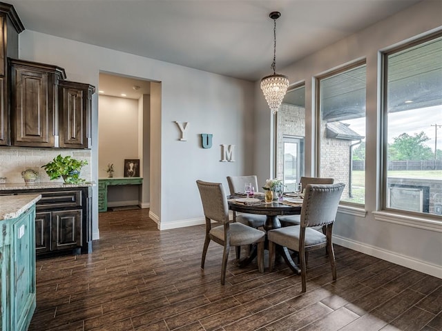 7437 SW 105th St, Oklahoma City, OK 73173 - dining space with baseboards, a chandelier, and dark wood-style floors