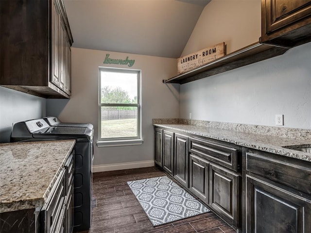 7437 SW 105th St, Oklahoma City, OK 73173 - washroom with cabinet space, baseboards, dark wood-style floors, and washer and clothes dryer