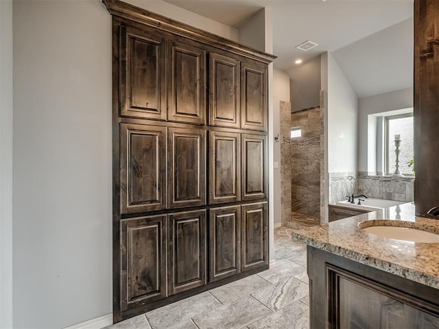 7437 SW 105th St, Oklahoma City, OK 73173 - bathroom featuring a walk in shower, visible vents, vanity, vaulted ceiling, and a garden tub