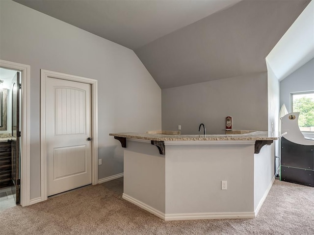 7437 SW 105th St, Oklahoma City, OK 73173 - interior space featuring a breakfast bar area, lofted ceiling, and light carpet