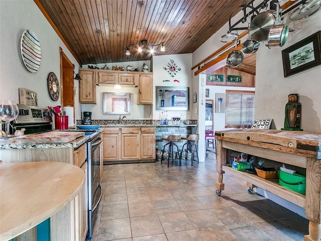 kitchen with a sink, light brown cabinetry, wooden ceiling, and stainless steel electric range oven