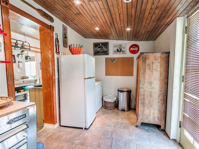 kitchen with recessed lighting, freestanding refrigerator, and wood ceiling