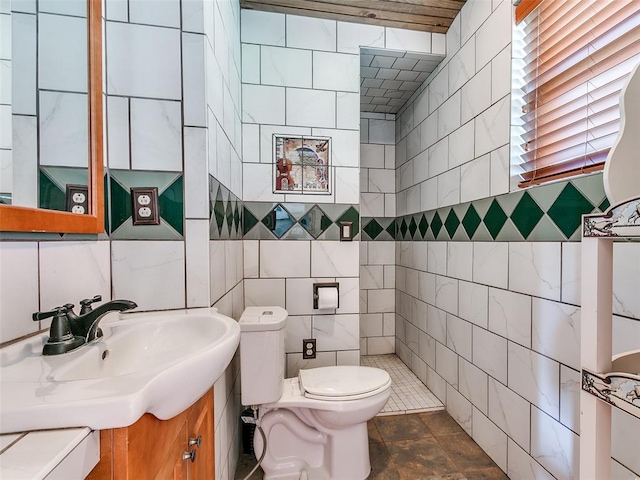 bathroom featuring tile walls, vanity, and toilet